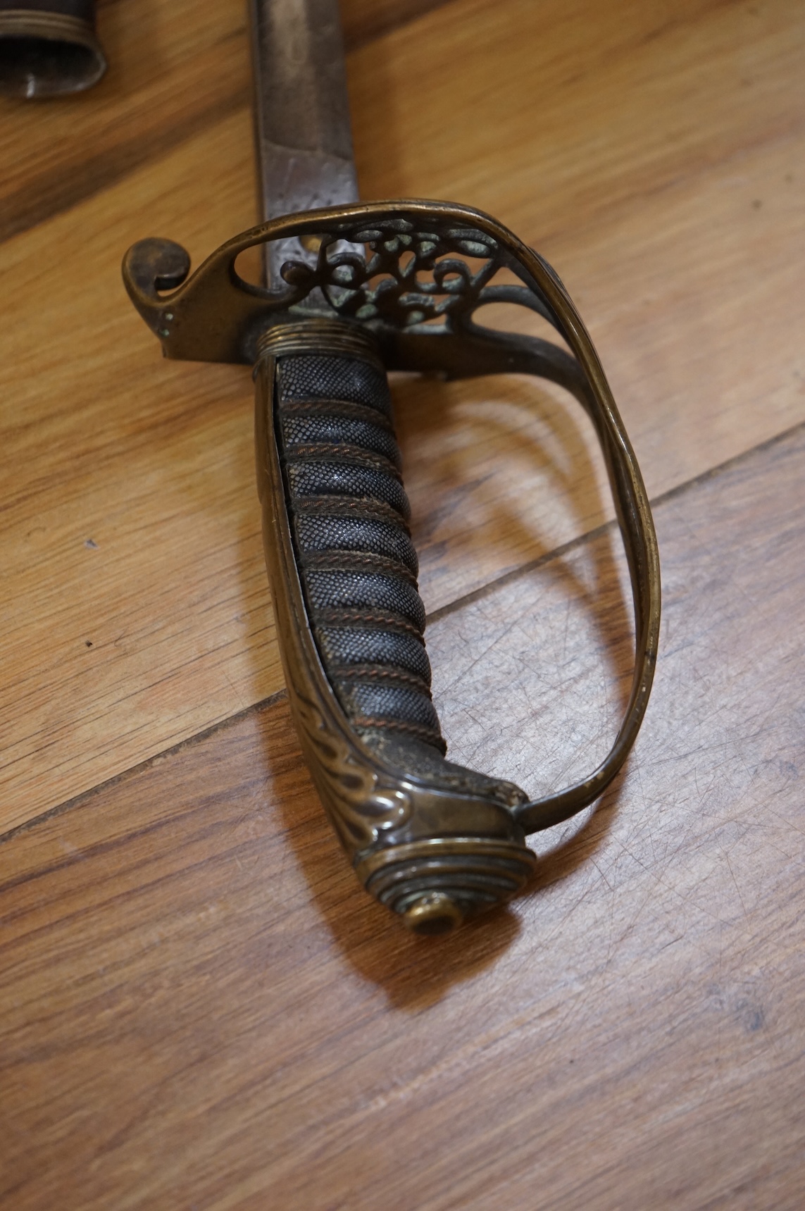 A Victorian 1845 pattern infantry officer’s levee sword, with slender blade etched; Hamburger Rogers & Co., and crowned VR and foliage, regulation pierced brass guard with folding side guard, wire bound fish skin covered